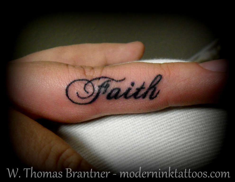 Faith over fear lettering tattoo on the wrist