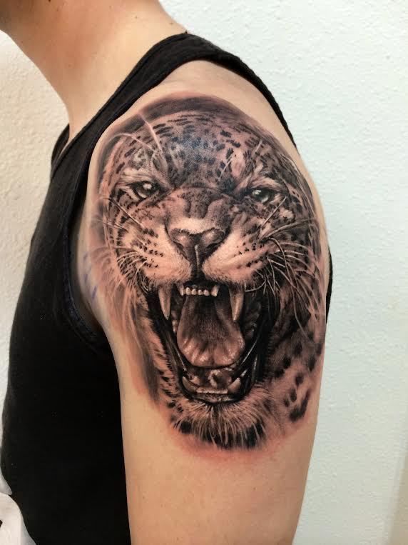 Sketchy style jaguar tattoo on the right shoulder