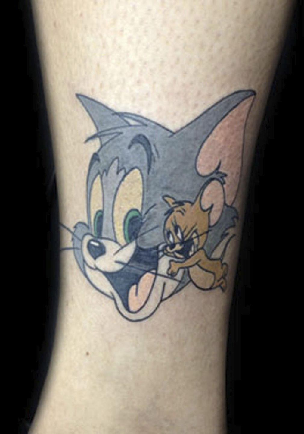 Cartoon style Tom and Jerry tattoo located on the