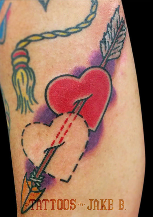 Heart and arrow tattoo on hand