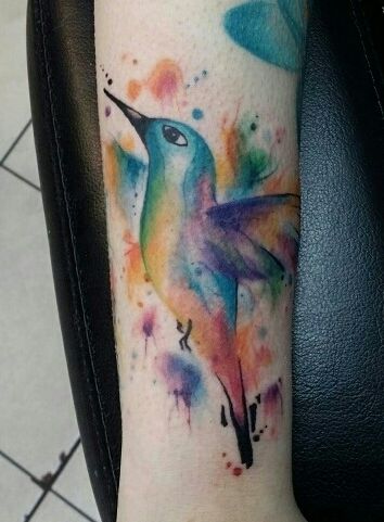 Premium Photo | Watercolor Hummingbird Tattoo Design on a Flat Surface