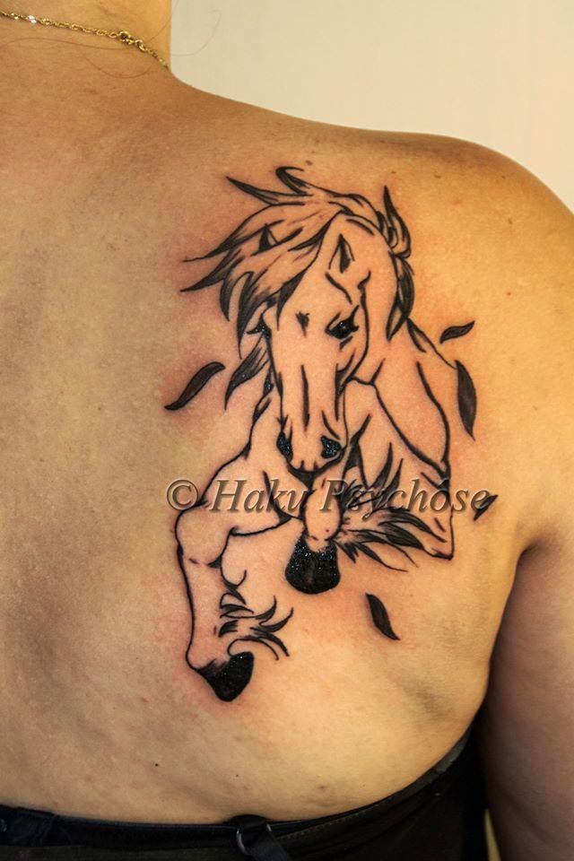 Tiny minimalistic horse tattoo located on the wrist.