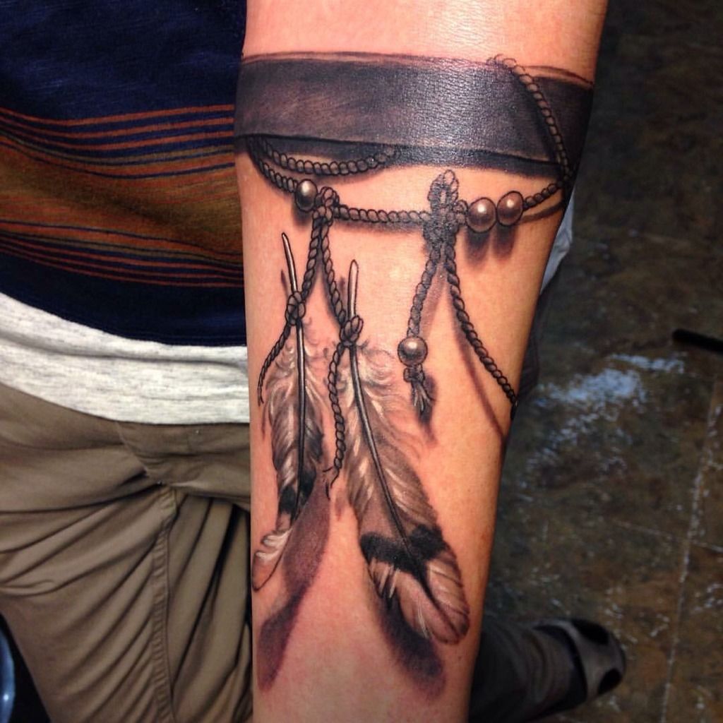 nicoleelizabethlaabs:black-and-gray-feathers-leather-string-beads-forearm