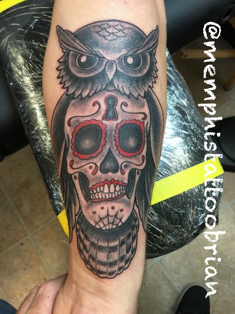 Forearm tattoo of an owl with a sugar skull on the