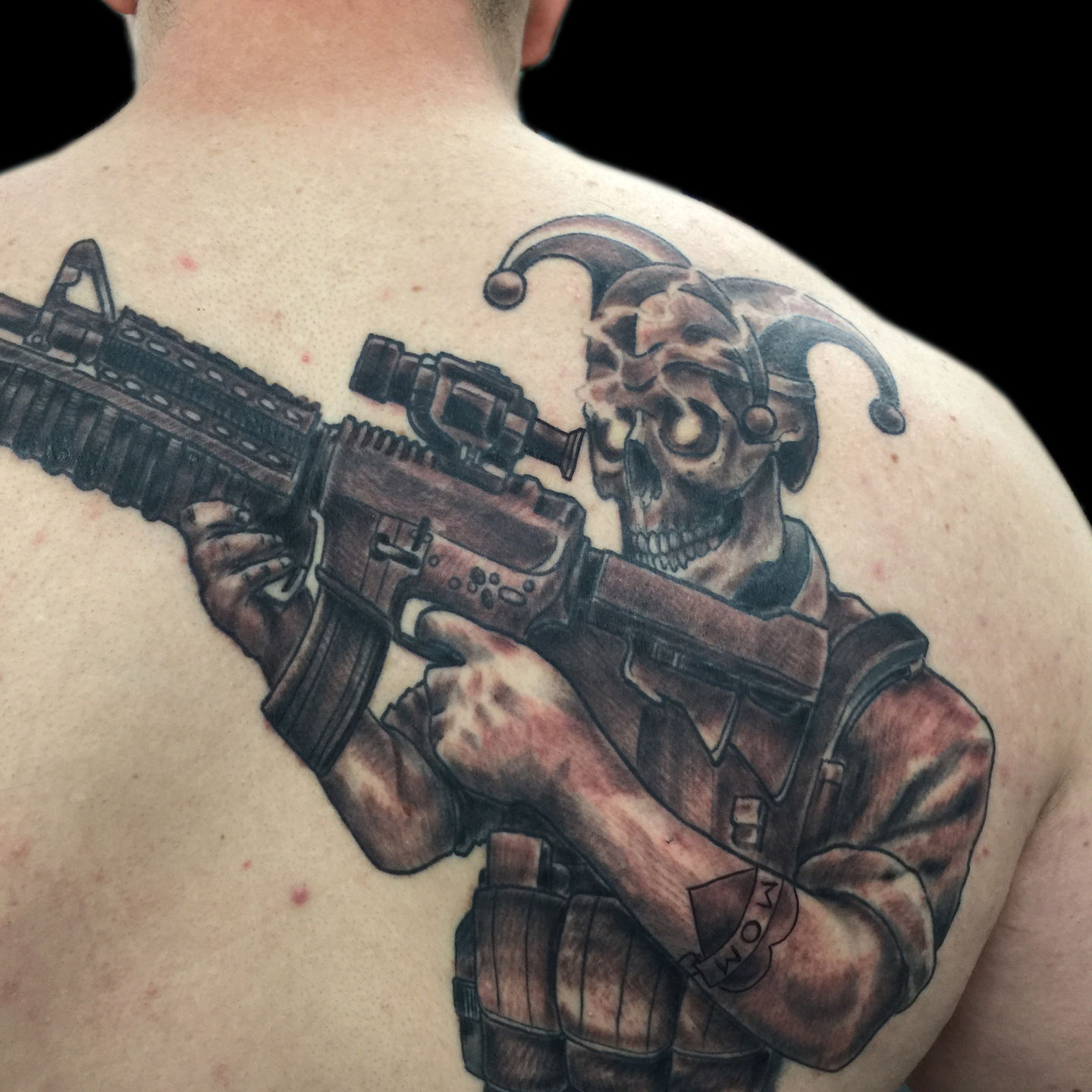 Black Ink Skull With Guns Tattoo On Man Chest