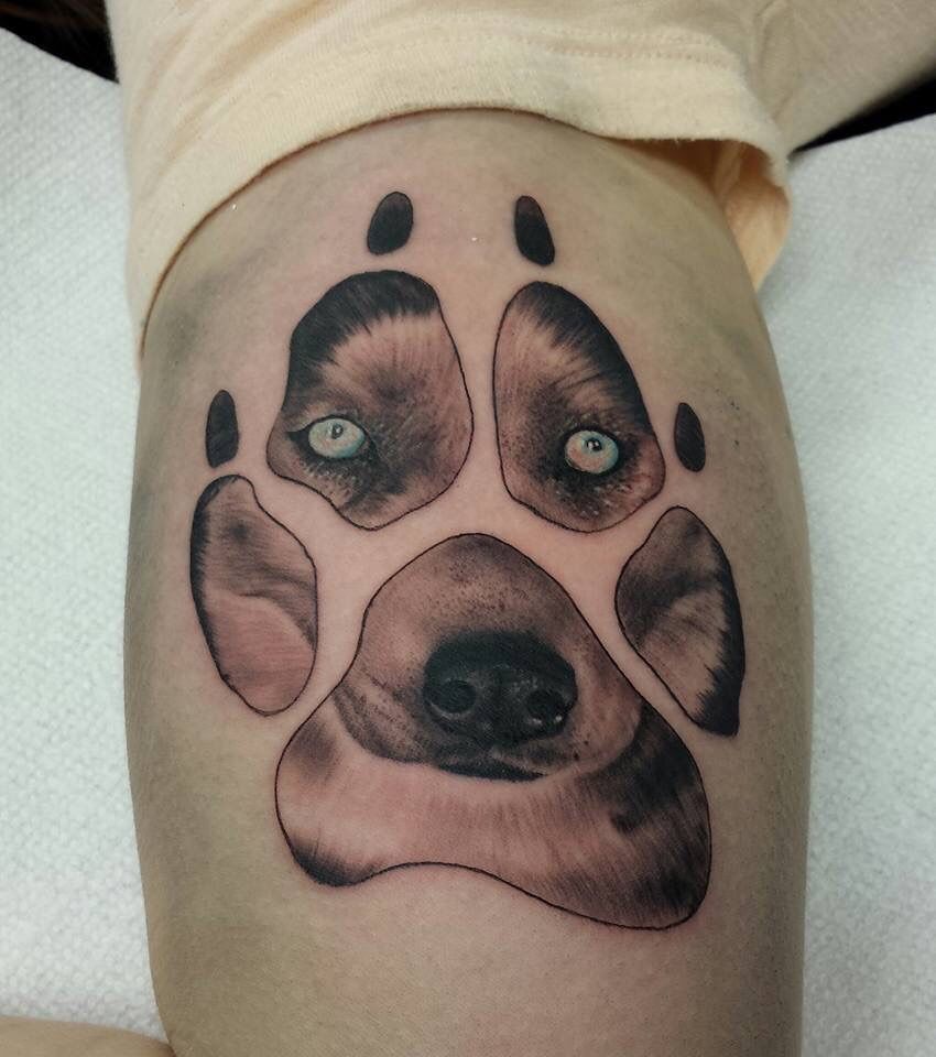 Unique Puppy face in paw tattoo