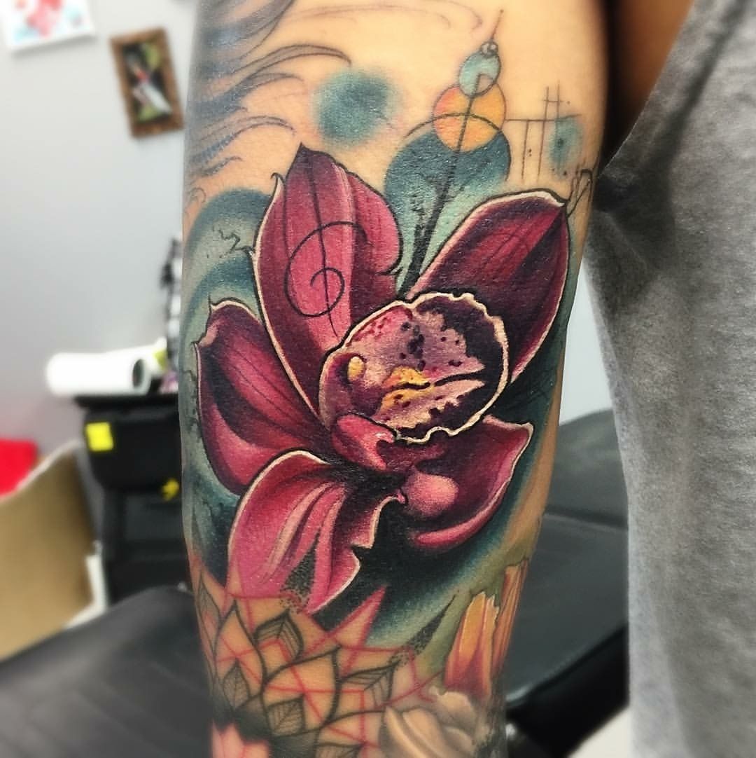 4 Orchid flowers tattooed on the inner arm.