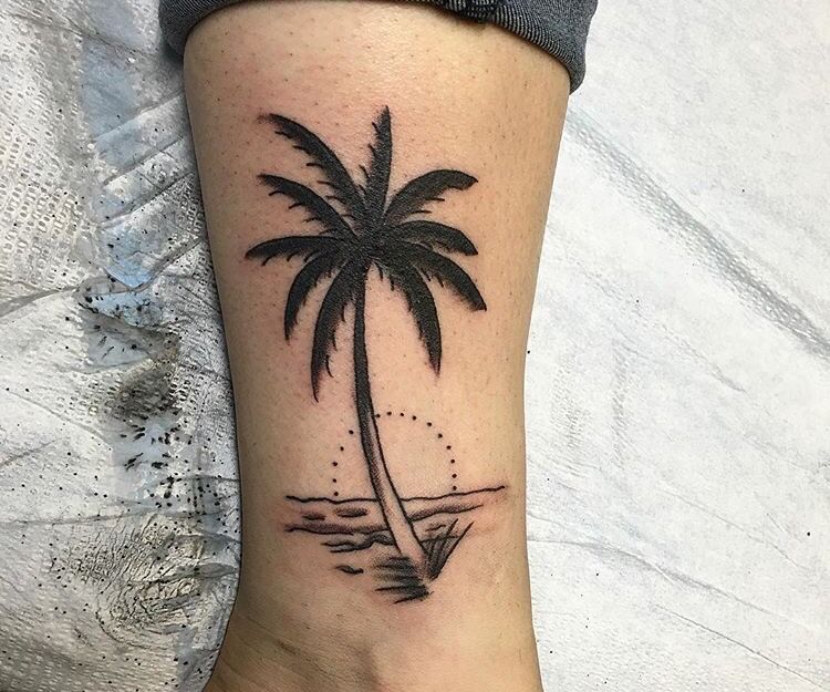 Beach sunset tattoo on the left inner forearm