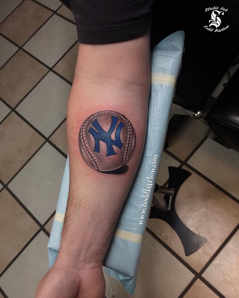 Wrist tattoo of the New York Yankees logo