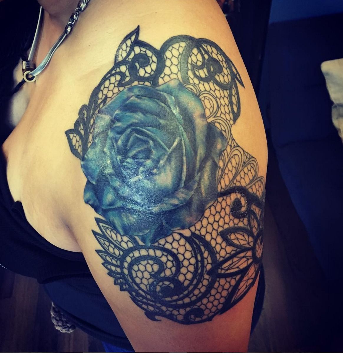 blue rose tattoo on shoulder
