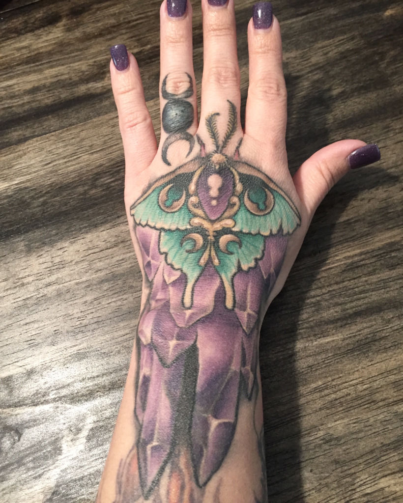 kerry-brown:moth-and-crystal-hand-tattoo-color-moth-crystal-hand -kerry-brown-once-in-a-blue-moon-tattoo-amethysts