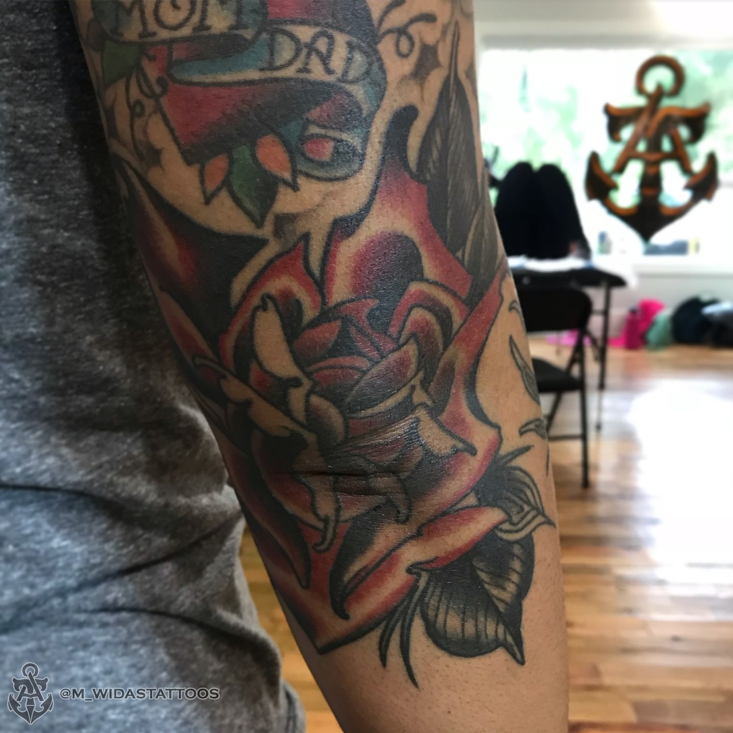 Colorful Traditional Flower Tattoo On Elbow