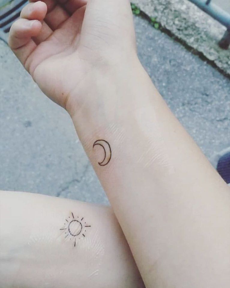 Tiny sun, moon and stars tattoo done on the wrist,