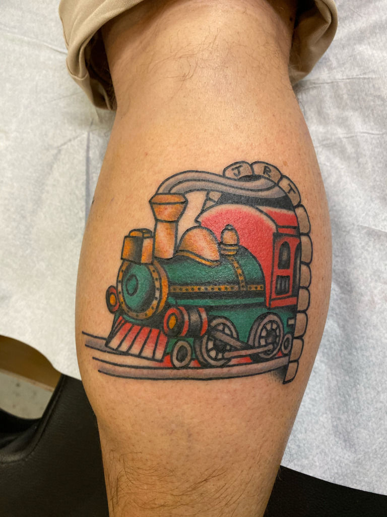 Train railway tattoo on Chris' left leg.