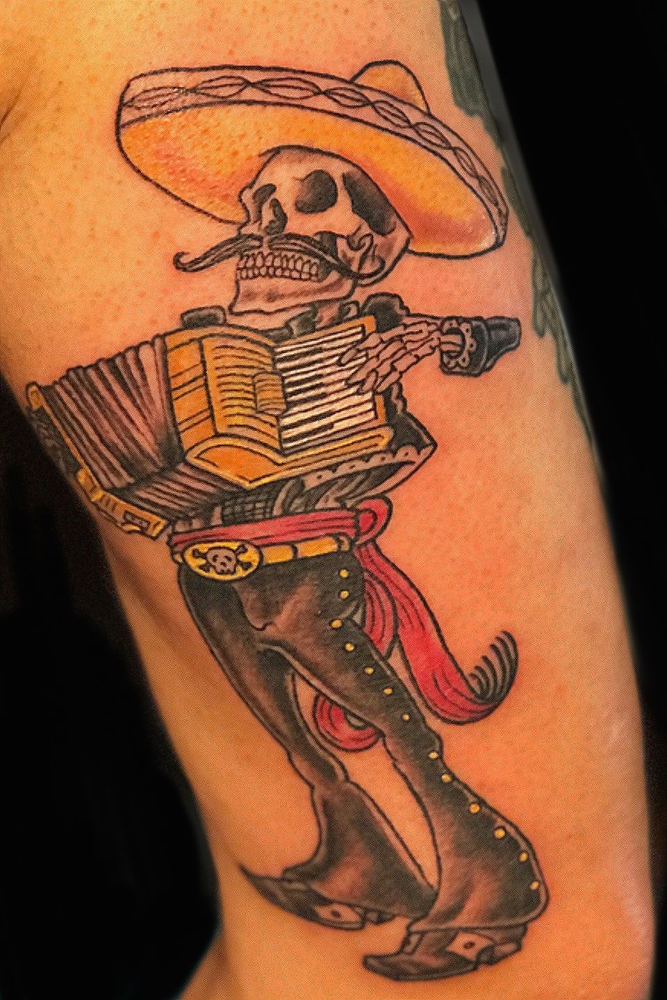 Mariachi tattoo located on the upper arm sketch work
