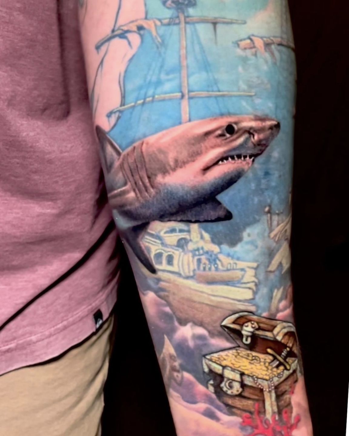 Rare striped shark tattoo on the right inner arm.