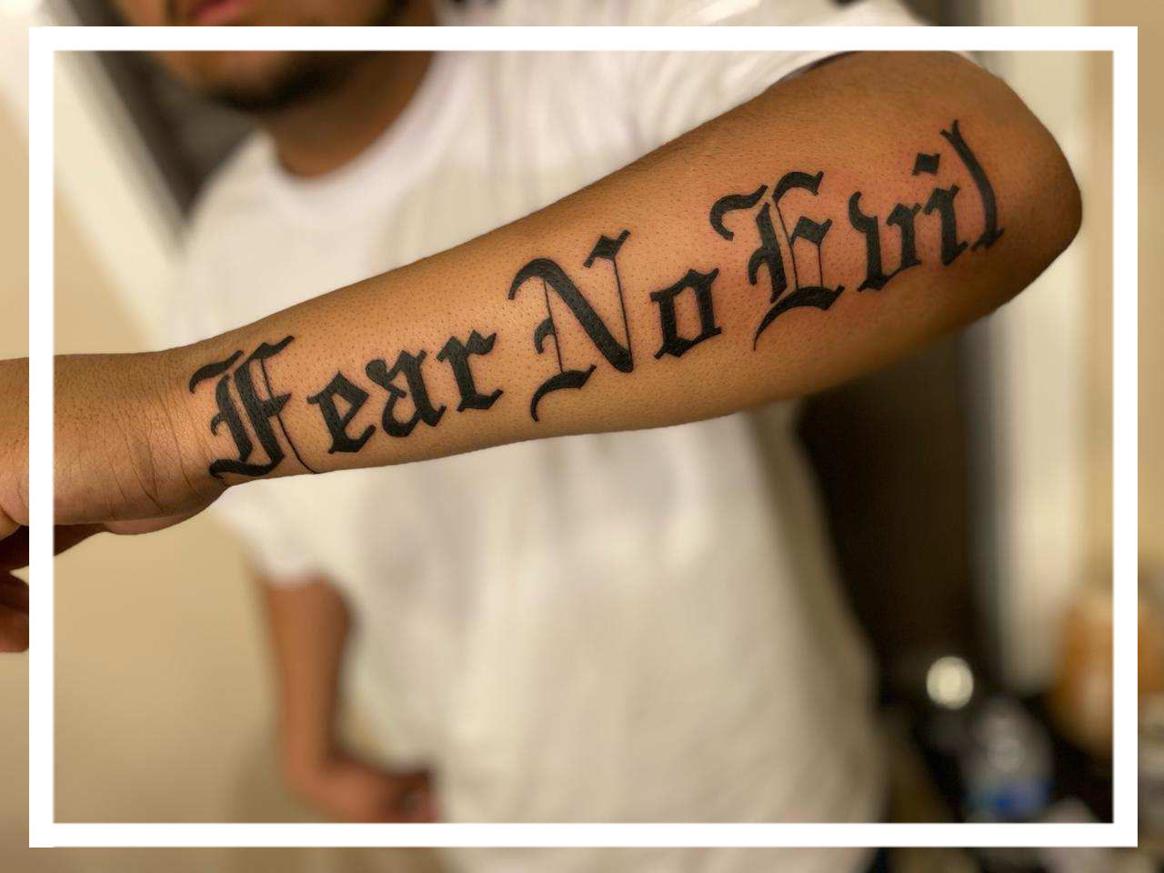 old english font tattoo on arm