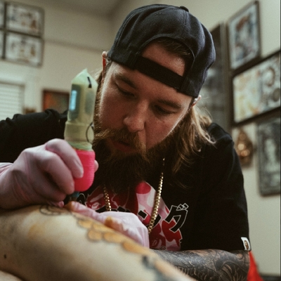 Florida Memory  Tattoo artist Jon Fort dipping the needle into ink   Pensacola Florida